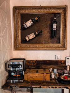 a picture of two bottles of wine and a microwave at Smith's house in Borgo San Dalmazzo