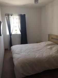 a bedroom with a white bed and a window at Iken Park Agadir in Agadir