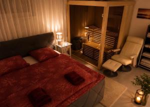 a small bedroom with a bed and a chair at Luxury Apartment Saya in Banja Luka