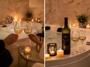 a person holding a glass of wine in a bath tub at Luxury Apartment Saya in Banja Luka