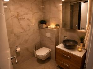 a bathroom with a toilet and a sink at Luxury Apartment Saya in Banja Luka