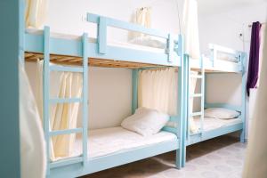 a bunk bed room with two bunk beds at Dub Hostel Saranda in Sarandë +38 photos