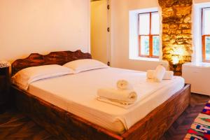 a bedroom with a bed with towels on it at Stone Villa Berat in Berat