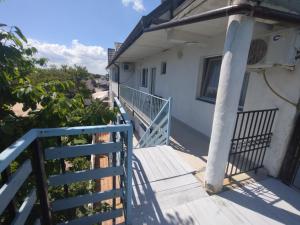 a balcony of a house with a blue railing at Casa Ștefan in 2 Mai