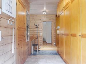 a hallway with wooden walls and a stool in a room at Kärpänpesä B in Syöte +12 photos