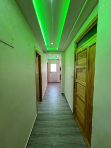 an empty hallway with green lights on the ceiling at costa in Oued Laou