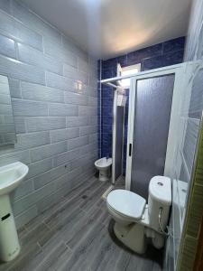 a bathroom with a toilet and a sink and a shower at costa in Oued Laou