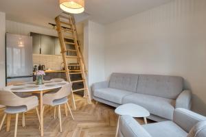a living room with a couch and a table at Łebska Osada- basen, parking in Żarnowska