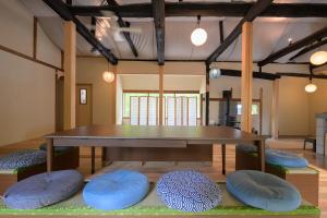 a dining room with a table and blue cushioned chairs at 高野神谷宿 一結 in Koyasan