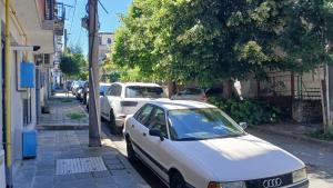 a white car parked on the side of a street at Studio Miguel in Veliko Tŭrnovo +3 photos