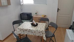 a kitchen with a table and chairs with a table and a television at Studio Miguel in Veliko Tŭrnovo