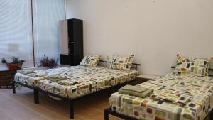 two beds sitting next to each other in a room at Studio Miguel in Veliko Tŭrnovo