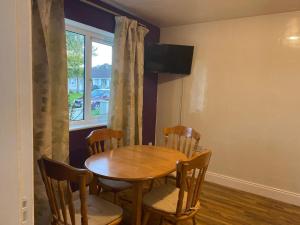 a dining room with a table and chairs and a window at Sunrise House in Cahersiveen