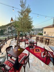 a group of tables and chairs on a patio at Stone Villa Berat in Berat