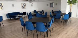 a conference room with blue chairs and tables in it at The Hillcrest Hotel in Widnes