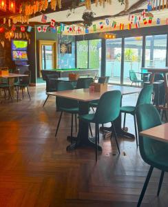 a dining room with tables and chairs in a restaurant at The Hillcrest Hotel in Widnes