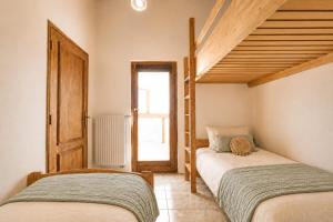 two twin beds in a room with a staircase at Eco Casa Branca in nature - hidden, unique paradise in Aljezur +62 photos