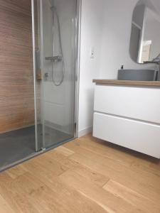 a bathroom with a shower and a wooden floor at Maison près de la plage in Sangatte +32 photos