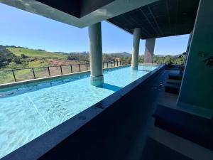a swimming pool with a view of a mountain at SKY design Alphaville by Rhouses in Barueri