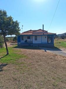 a white house with a tree in front of it at La casa di lefki in Elafonisos
