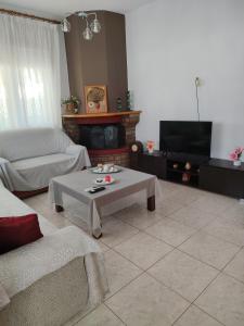 a living room with a couch and a coffee table at Xaris House in Ávaton
