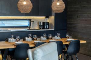 a dining room with a wooden table and chairs at Villa Noel in Ylläsjärvi