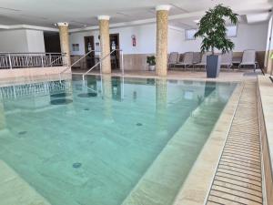 a large pool of water in a hotel room at Zenit Wellness Hotel Balaton in Vonyarcvashegy