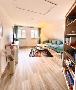 a living room with a couch and a table at Inselglück Föhr in Wrixum