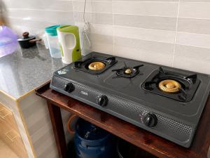 a stove top oven sitting on top of a counter at Fahari House in Embu
