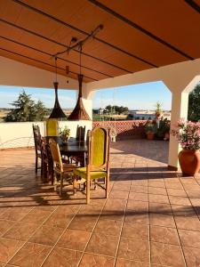 a table and chairs on a patio with a view at Quinta Monte da Azinheira in Amareleja