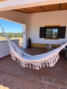 a hammock in the living room of a house at Quinta Monte da Azinheira in Amareleja