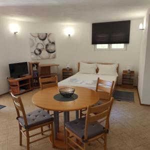 a living room with a table and a bed at Apartments Ada in Primošten