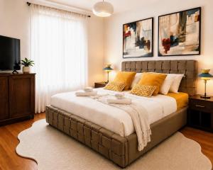a bedroom with a large bed with orange pillows at Apartments Villa Marid in Opatija +111 photos