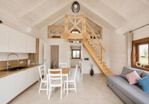 a kitchen and living room with a staircase in a tiny house at KOPUVA seaside villas in Nida