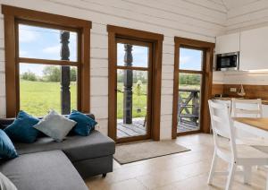 a living room with a couch and a table at KOPUVA seaside villas in Nida +32 photos