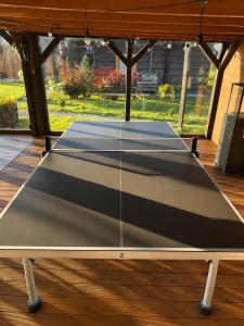 a ping pong table in a gazebo at KOPUVA seaside villas in Nida