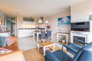 a living room with a couch and a table at Appartementencomplex Juliana 148 in De Koog