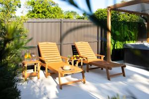 two chairs and a table on a patio at Boho Bliss - Reset & Recharge Wellness House in Naples