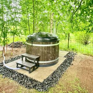 a wooden barrel with a picnic bench in a park at Hotel Ilomantsi North Star in Ilomantsi