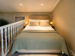 a bedroom with a large bed with two lamps at Paddock View Loft Countryside Retreat in Thornhill