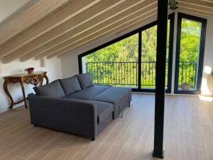 a living room with a couch and a large window at La Llarena in La Isla