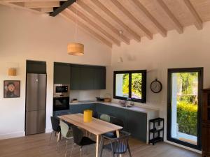 a kitchen and dining room with a table and chairs at La Llarena in La Isla