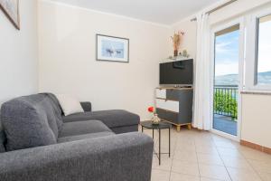 a living room with a couch and a television at Blue Horizon Retreat in Trogir +25 photos