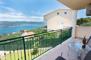 a balcony with a table and a view of the water at Blue Horizon Retreat in Trogir