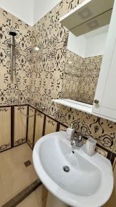 a bathroom with a sink and a mirror at EG Beach Apartments 105A in Lezhë +35 photos
