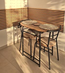 a wooden table with two chairs and a table and a table at Studio Miška in Bohinjska Bela