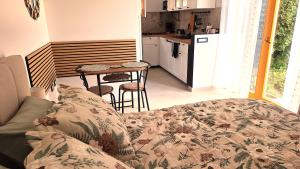 a living room with a couch and a table in a kitchen at Studio Miška in Bohinjska Bela