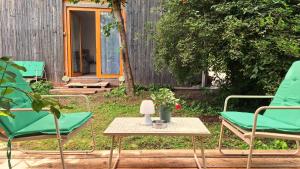 a patio with two chairs and a table and a fence at Studio Miška in Bohinjska Bela