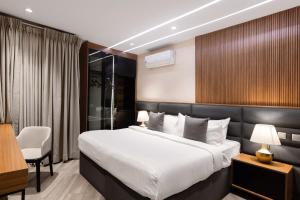 a hotel room with a bed and a desk at Yellow Trumpet Iris Maitama in Abuja +26 photos