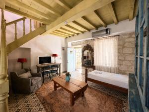 a living room with a bed and a table at Marge Hotel Adult Only 12 plus in Ilıca